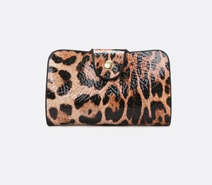 Detail of leopard print clutch bag with glossy finish and golden metal buckle