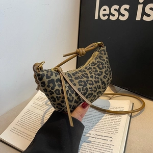 Leopard print crescent bag with leather knotted strap and tassel zipper closure