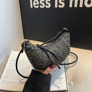 Leopard print croissant bag with black knotted leather strap and gold hardware