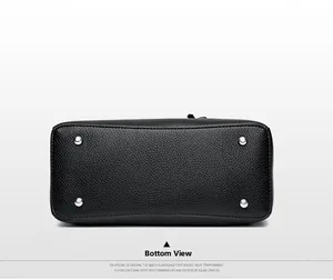 Detailed base of black lychee leather bag with four silver protective metal studs