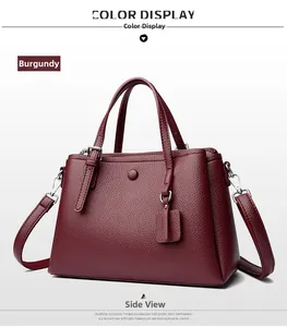 Detail view of fuchsia lychee pattern leather tote bag with silver hardware and top handles
