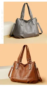 Detail of panel stitched faux leather tote bag with round handles and silver hardware