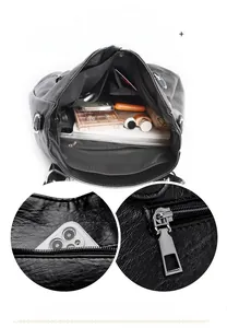 Detail view of black PU leather tote bag interior with multiple pockets and zippers