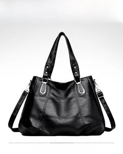 Front view of black quilted faux leather tote bag with silver U-shaped metal hardware