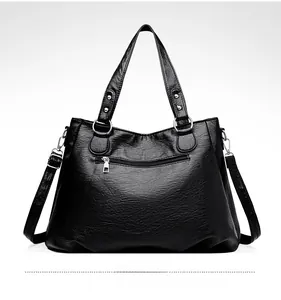Close-up of black litchi pattern PU leather tote bag back view with metal zipper pocket