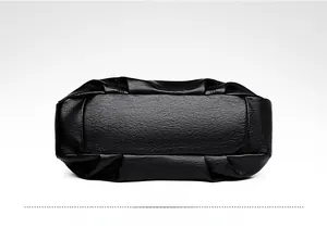 Close-up of the pebbled PU leather bottom with textured stitching on the black tote bag