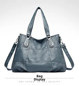 Detail of lake blue tote bag with lychee grain leather and adjustable shoulder strap