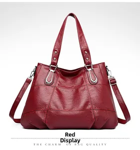 Detailed close-up of dark red oil-wax leather shoulder bag with vintage quilted stitching