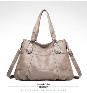Detail view of camel PU leather handbag with natural texture and silver hardware accents