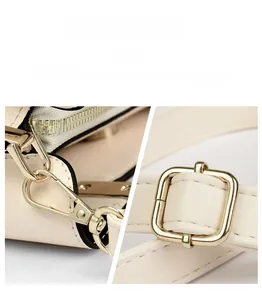 Detailed macro view of light beige leather strap with premium gold hardware buckles