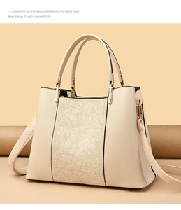 Detailed view of off-white handbag featuring elegant six-grid floral embossed patterns