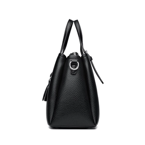Side view of a large capacity black litchi grain leather tote bag with silver metal D-rings