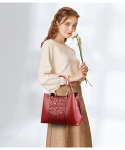 Detail of red embroidered floral pattern on premium leather handbag for women