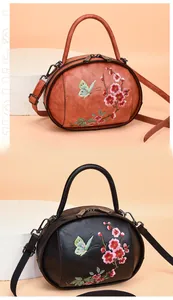 Detailed embroidery of plum blossoms and butterflies on vintage leather handbag