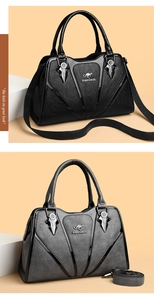 Close-up of black and grey textured faux leather handbags with kangaroo logo detail