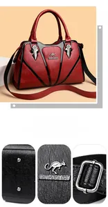 Close-up of red and black leather bag showing silver hardware and anti-wear bottom studs