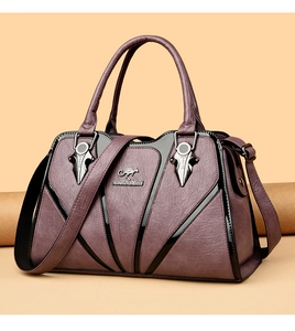 Detail view of purple lychee textured faux leather bag with metallic kangaroo emblem