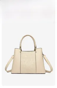 Detail of elegant beige tote bag featuring square embossed floral patterns and gold hardware