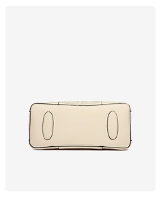 Bottom view of beige embroidered bag featuring reinforced oval patches and black oil edges