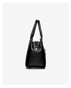 Side view of large black waterproof tote bag showing textured leather and zipper details