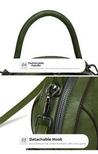 Detail of dark green vintage leather bag with rounded handle and metal hook connectors