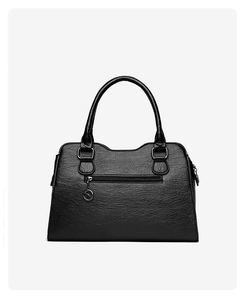 Detail of black textured leather bag with back zipper pocket and metal kangaroo pendant