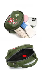 Internal view of vintage green embroidered bag showing capacity for phone and umbrella