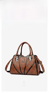 Detail of brown litchi pattern leather tote bag with metal kangaroo logo and V-shaped trim