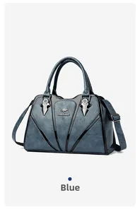 Detailed close-up of blue textured leather tote with silver kangaroo logo and V-shaped trim