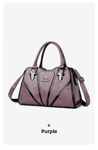 Detail of purple textured leather bag with dark silver hardware and adjustable strap