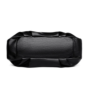 Bottom view of black faux leather tote bag with lychee texture and pleated details