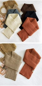 Detailed close-up of ribbed knit texture on various solid color winter scarves