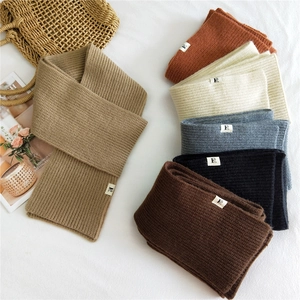 Thick knitted winter scarves for women in multiple neutral colors with logo patch