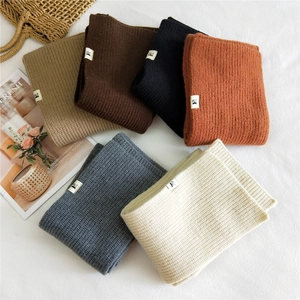 Thick knit solid color scarves in six classic tones with a vertical ribbed pattern