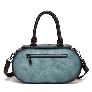 Vintage cyan blue cylinder boston bag with brown handles and adjustable crossbody strap