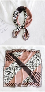 Détail d'un foulard carré en soie à imprimé léopard et motifs géométriques rose et brun