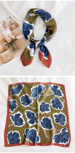 Détail du foulard en soie avec tulipes bleues sur fond vert olive et bordure rouge