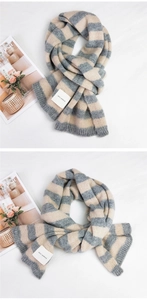 Detail view of thick striped knit scarf with grey oatmeal patterns and SEFZ woven label