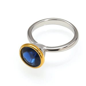 Elegant silver and gold-toned ring featuring a brilliant round-cut blue cubic zirconia stone