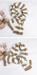 Detailed close-up of striped knit scarf texture with a woven SEFZ brand label