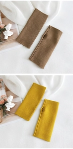 Detail of ribbed knit fingerless gloves in brown and yellow with thumb hole design