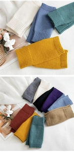 Macro shot showing diverse colorful knitted arm warmers with detailed ribbed elastic cuffs