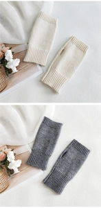 Detail of fingerless knit gloves in white and grey showing ribbed cuffs and thumb hole