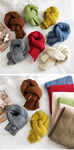 Macro detail of thick striped knit scarves showing soft texture and various colors