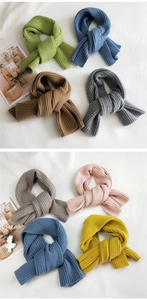 Detail of multi-color thick knit scarves showing warm ribbed texture and various winter shades