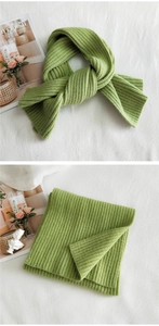 Detail of green ribbed knit scarf showing thick texture and warm woven fabric pattern