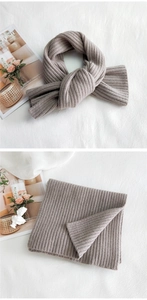 Close-up of brown striped rib-knit scarf showing thick texture and knotted style