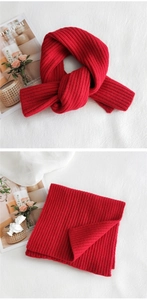 Close-up of thick red ribbed knit scarf showing texture and soft wool-like material