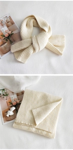 Detailed macro view of cream white knit scarf texture and vertical striped pattern
