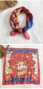 Detail of red festive square scarf with cartoon ox and lucky motifs in cotton-linen fabric